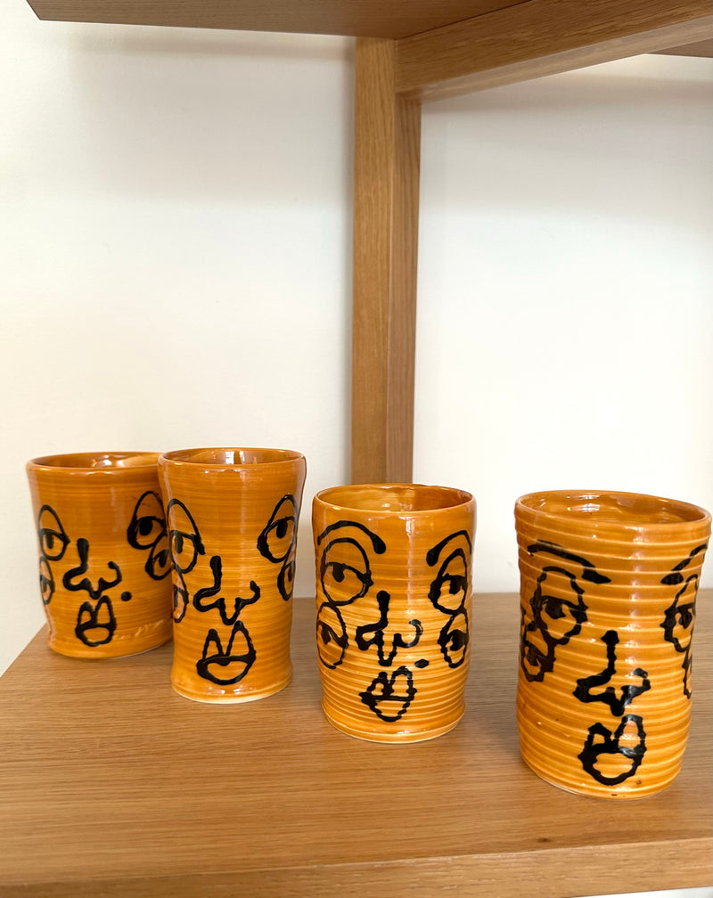 Burnt Orange Cylinder Ceramic Cup with Black Faces (4 avail)